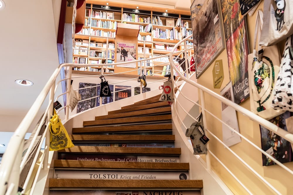 Bücher, Fachliteratur und vieles mehr gibt es in der Buchhandlung Heyn. Die breite Stiege, die man am Bild sieht, führt in den ersten Stock zu noch mehr Auswahl.