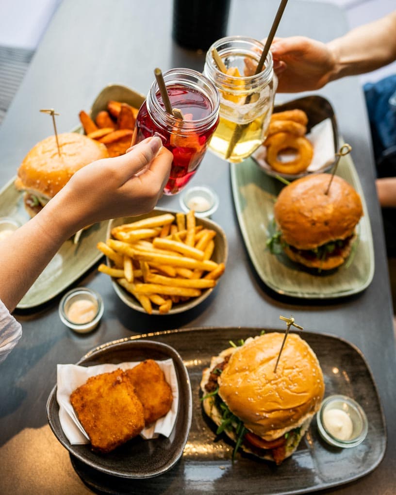 Burger, Pommes, frittierte Zwiebelringe und Drinks im Le Burger in Klagenfurt 