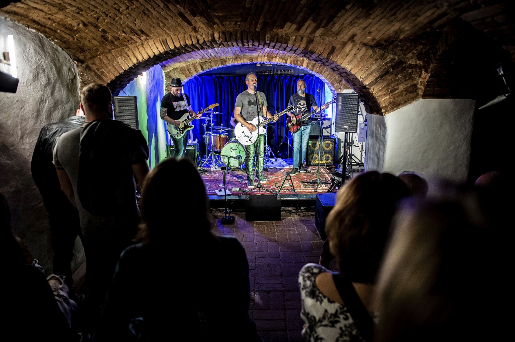 Eine Drei-Mann-Band performt auf der kleinen Bühneim Gewölbekeller des Dok04 der Hafenstadt