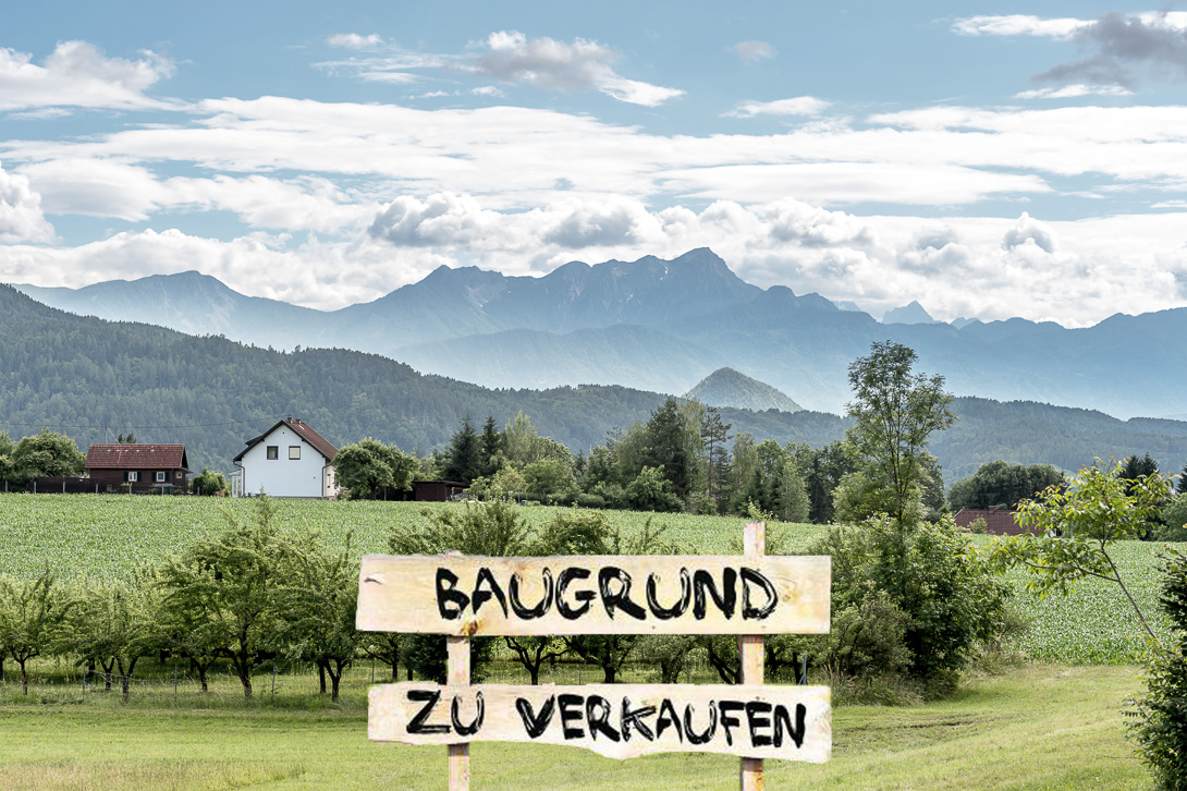 Bild eines Baugrunds mit Holzsschild mit Aufschrift "Baugrund zu verkaufen"