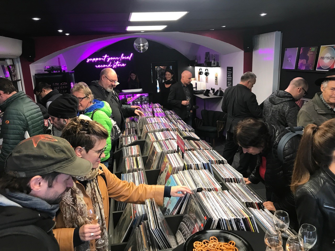 Blick von schräg oben in den neuen Plattenladen Drehscheibe in Klagenfurt, wo bei der Eröffnung viele Besucher die Auswahl an Schallplatten begutachteten