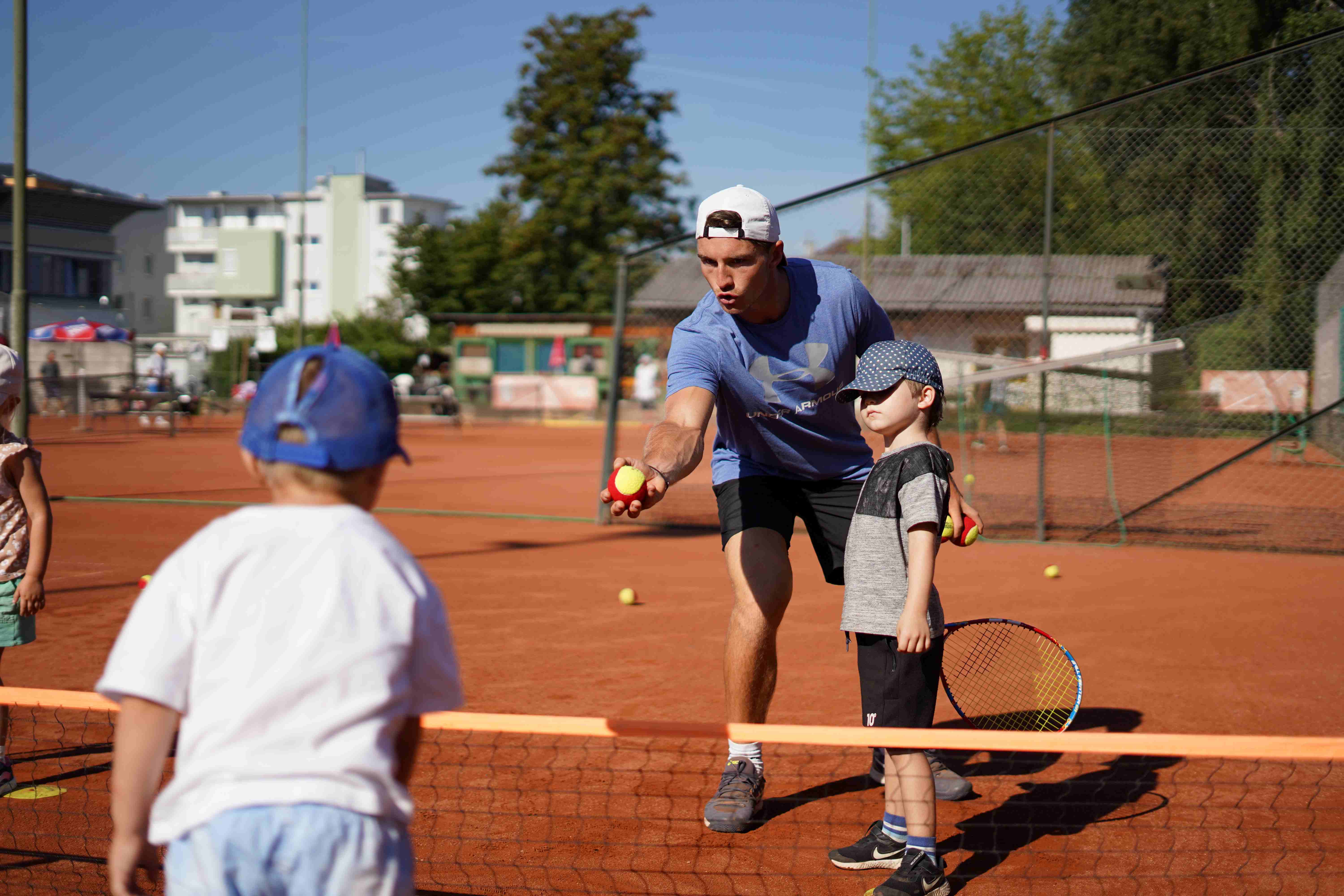 Szene vom Allstep Sportscoaching in Klagenfurt mit Kindern beim Training am Tennisplatz